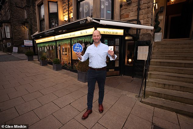 David Straker poses with his cheese. He has issued the following warning: 'The next time you see a suspicious cyclist with a backpack full of dairy, think of us and our lost Brie. And remember: crime may pay, but cheese always costs'