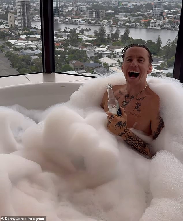 I'm A Celebrity winner Danny Jones makes the most of the luxury Gold Cost hotel as he sipped a beer in a hot tub on Monday after three weeks in the Jungle