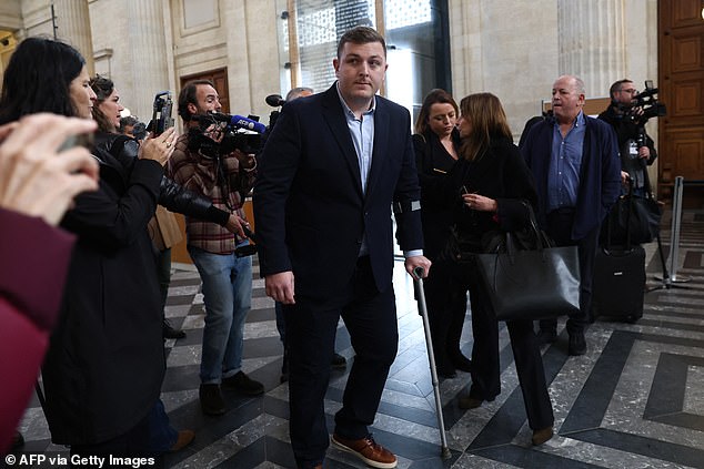 Irish rugby player Denis Coulson (C), accused of gang rape, talks to his lawyer Corinne Dreyfus-Schmidt (3R) before his trial at the Bordeaux courthouse, south-west Bordeaux, on December 2, 2024