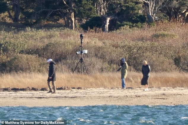 Jill Biden (right) and Ashley Biden (center) walk on their private beach as a Secret Service agent walks in front of them