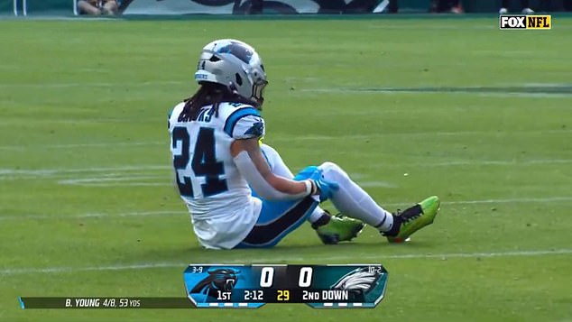 Jonathon Brooks clutches his knee after going down on a non-contact play for the Panthers