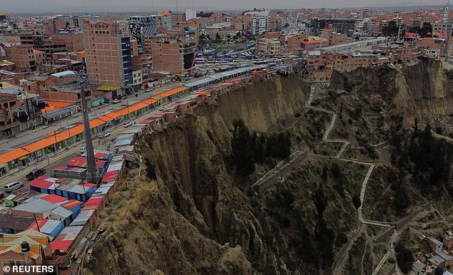 A drone shot shows a row of houses, known locally as 'suicide houses', dwellings built on the edge of an earthen cliff and often serving as workplaces for Aymara shamans, in El Alto, Bolivia, December 3, 2024