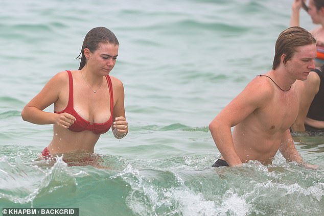 She and her boyfriend went for a quick dip before returning to the sand to lounge on their beach towels