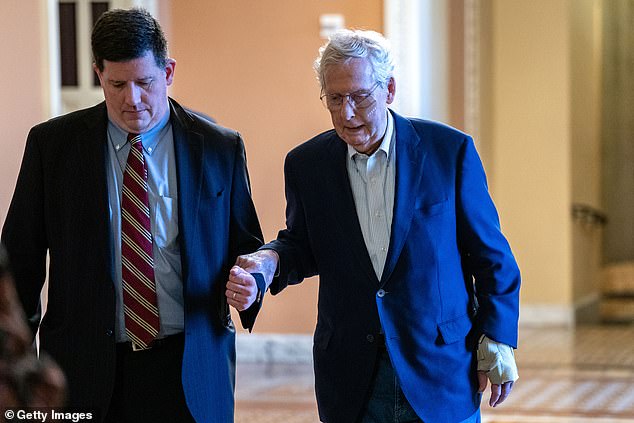 U.S. Senate Minority Leader Mitch McConnell (R-KY) is assisted by staff as he heads to the Senate chamber to vote on December 11, 2024 in Washington, D.C.