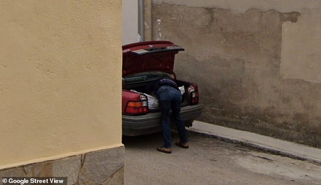 Another angle shows the man, who was wearing jeans and a blue jacket, leaning further into the trunk as he straps on the large white bag he added to it