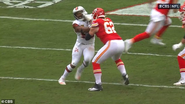 Myles Garrett slaps his hand in his face as he runs into Chiefs guard Joe Thuney