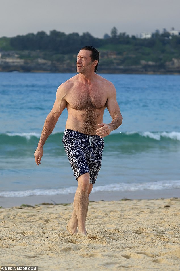 Hugh Jackman put his impressively sculpted physique on display as he went for an early morning swim at Bondi Beach on Monday