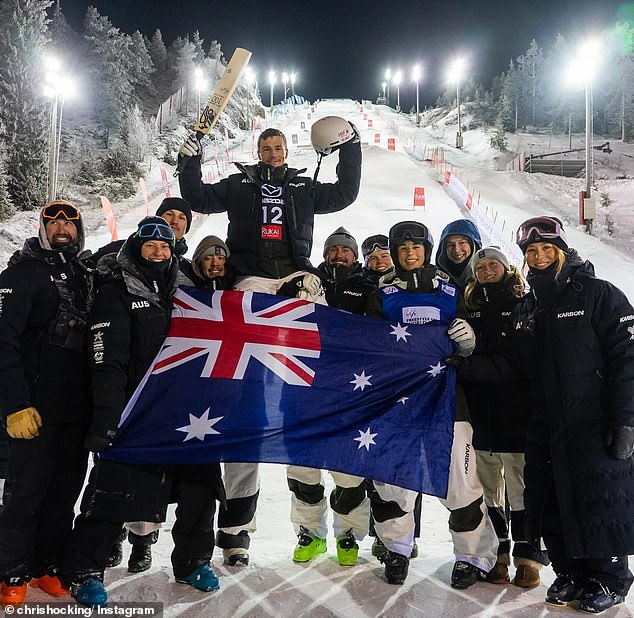 Aussie Olympic moguls ski champion Matt Graham raises a cricket bat in honor of his 100th World Cup event