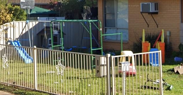 The front yard of the house remained littered with children's play equipment