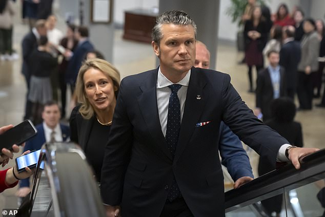 Pete Hegseth, President-elect Donald Trump's nominee for Secretary of Defense, is accompanied by his wife Jennifer as they walk through the basement of the Capitol. He met with several senators on Wednesday about his upcoming nomination