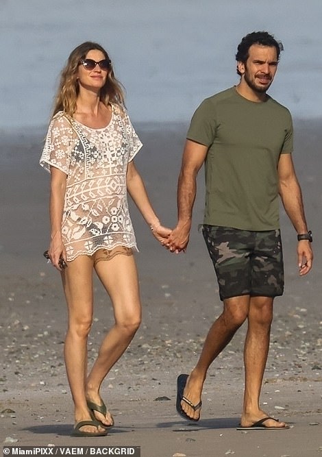 The supermodel, 44-year-old and 36-year-old jiu-jitsu instructor, who are expecting their first child together, looked blissfully happy as they walked hand-in-hand along a quiet beach in Central America and took in the spectacular views on the ocean all around. them