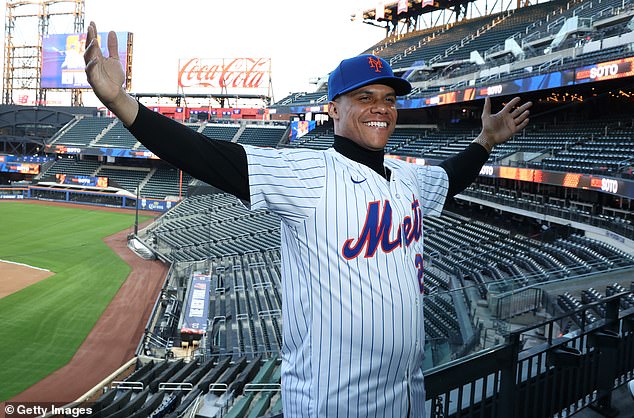 Juan Soto of the Mets poses with his new uniform after his introductory press conference