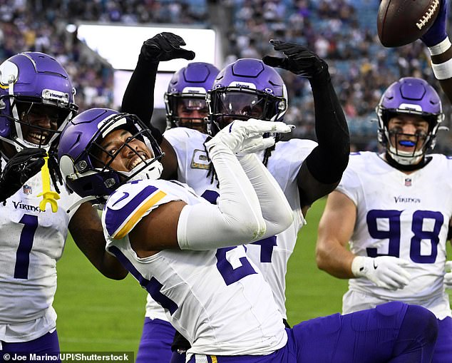 Global star: NFL star Camryn Bynu (pictured, center) imitated Raygun's routine as he scored a touchdown last month