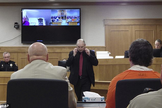 Ian Cramer, right, sits in court during his sentencing proceedings as Mercer County State's Attorney Todd Schwarz, center, returns to his seat in Stanton, North Dakota, on Monday