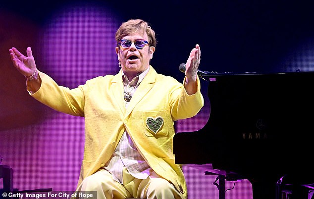 Sir Elton John's friends are reportedly 'deeply concerned' for the music legend as he works harder than ever amid his ongoing health problems (photo ion stage in October)