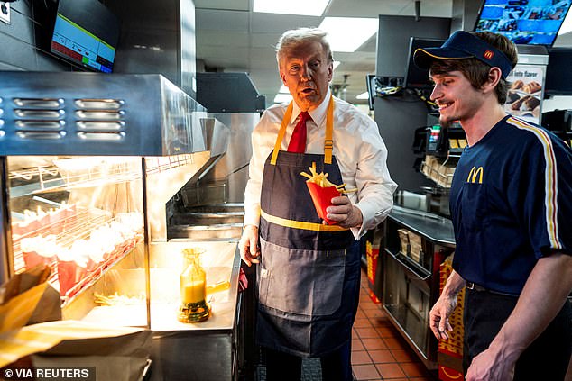 Donald Trump works behind the counter during a visit to McDonalds in Feasterville-Trevose, Pennsylvania, USA, October 20, 2024