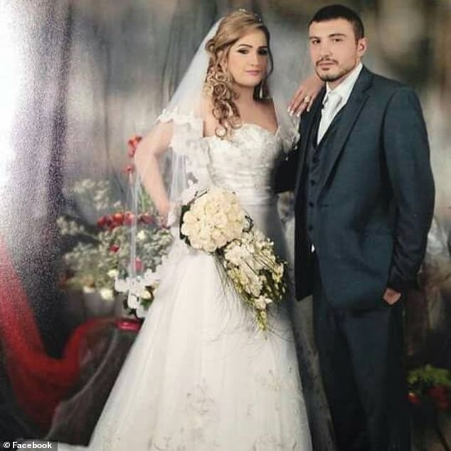 The couple stands arm in arm and while Mrs Hawatt carries a bouquet of white roses in her hand, the couple poses for the camera in their wedding suits (pictured)