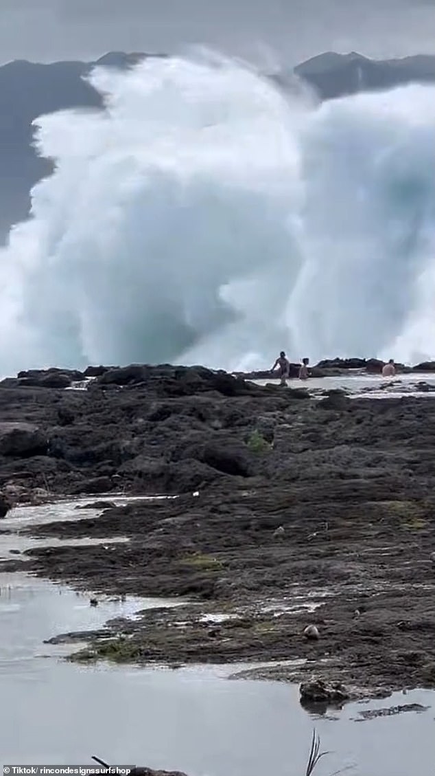 A surfing expert captured footage of three swimmers being pounded by waves on a north shore beach in Oahu, Hawaii, on November 29.