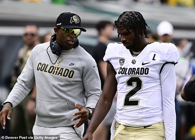 Colorado Buffaloes head coach Deion Sanders talks with his son QB Shedeur Sanders