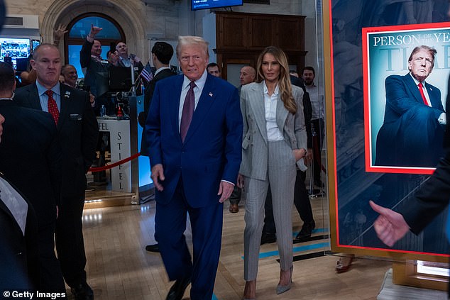 President-elect Donald Trump walks onto the trading floor of the New York Stock Exchange with his wife Melania after being named TIME's "Person of the Year"