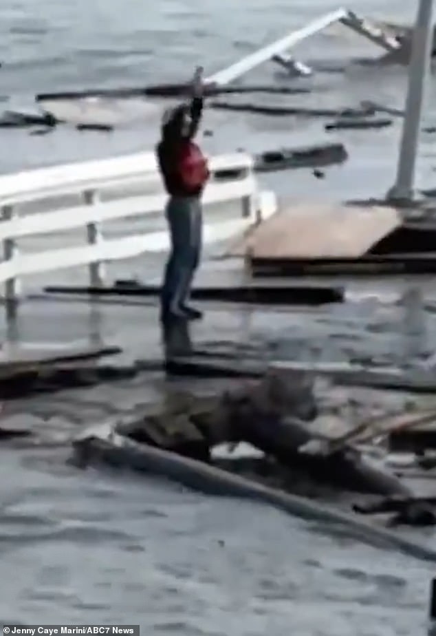 One of the city's construction workers waves for help