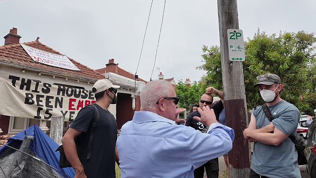 A neighbor who lives across the street from the three vacant houses told the group, “You're all idiots. This is not your house, this has nothing to do with you. You guys just have to move on.”