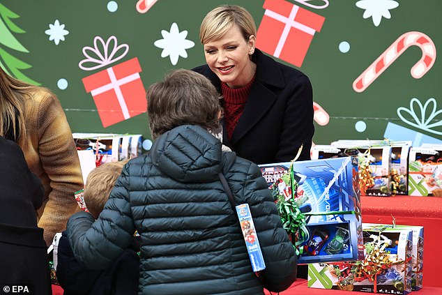 Charlene talks to families who visited the palace for last year's gift giving event