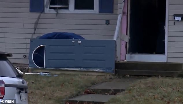 During the police raid, a door appeared to have been smashed and left on the ground