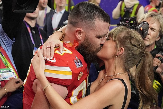 Taylor Swift and Travis Kelce share a kiss on the field after the Chiefs won the Super Bowl