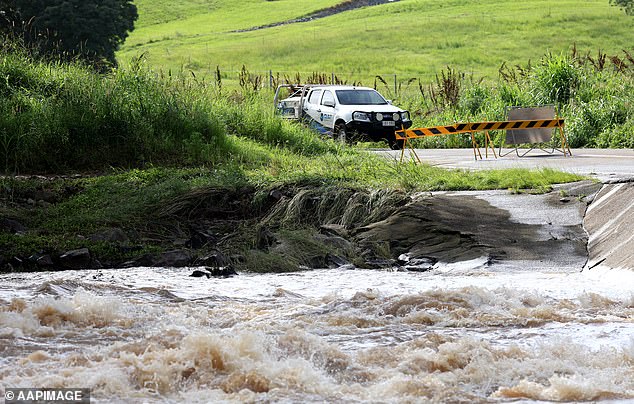 The material, found at the Mount Crosby water treatment plant, formed as a result of heavy rainfall and warm weather in parts of the state (photo of a flooded road in Queensland)