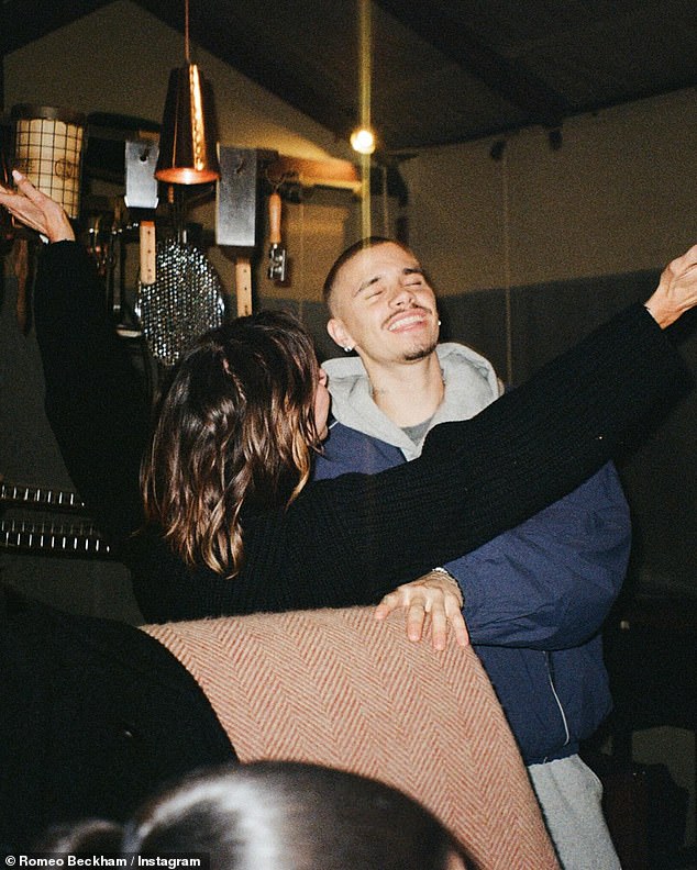 Romeo also shared a sweet photo of himself dancing with fashion mogul Victoria, who threw her arms in the air in joy