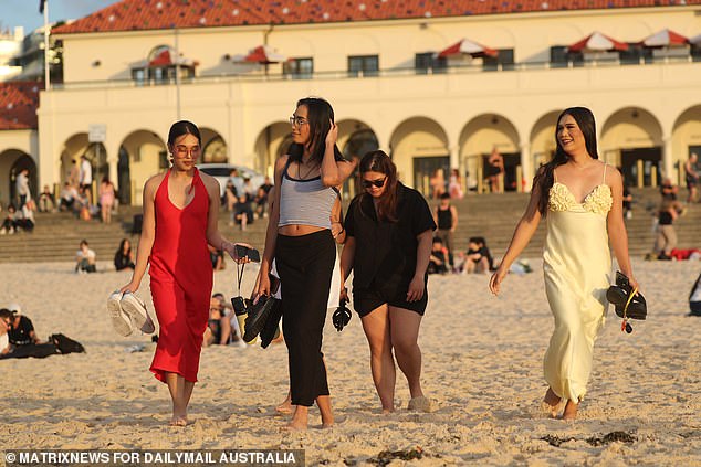 As fitness fanatics completed their morning jog, revelers, still dressed to the nines, strolled through the sand