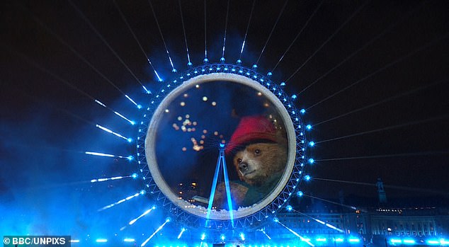 A huge fireworks show lit up Big Ben despite storm warnings forcing many displays to be scrapped today, leaving many fans stunned by a 'world first' Paddington Bear cameo