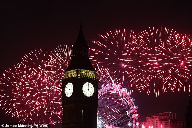 Fireworks light up the sky above the Elizabeth Tower, also known as Big Ben, and the London Eye in central London during New Year's celebrations