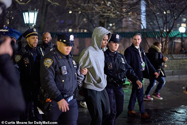 Photos show the moment Hawkins was picked up by police and escorted through the subway to custody