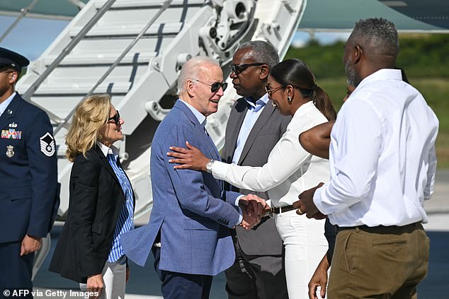 Biden and Jill shake hands with House Representative Stacey Plaskett, Democrat of the Virgin Islands, before boarding Air Force One