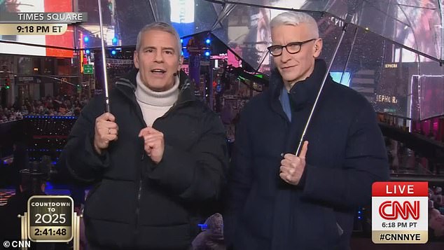 CNN's Andy Cohen and Anderson Cooper were forced to take cover from the downpour