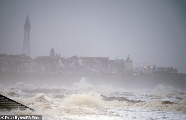 Waves crashing against the coast in strong winds at Cleveleys Beach near Blackpool on New Year's Eve