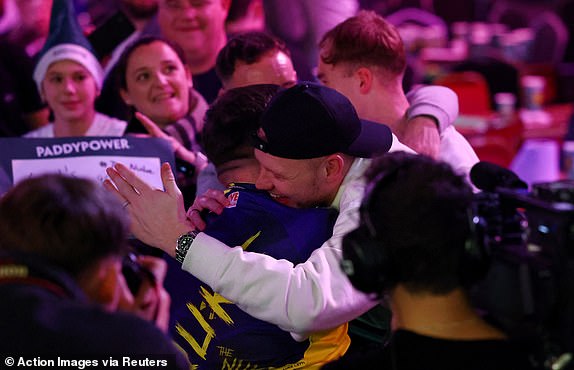 Darts - PDC World Darts Championship 2025 - Alexandra Palace, London, Great Britain - December 30, 2024 Luke Littler celebrates with Southampton's Aaron Ramsdale after winning his fourth round match against Ryan Joyce Action Images via Reuters/Andrew Boyers