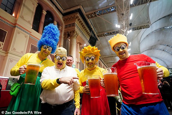 Fans dressed as characters from "The Simpsons" during day fourteen of the Paddy Power World Darts Championship at Alexandra Palace, London. Date of photo: Wednesday January 1, 2025. PA Photo. See PA story DARTS World. Photo credit should read: Zac Goodwin/PA Wire. RESTRICTIONS: Use subject to restrictions. Editorial use only, no commercial use without prior permission from the rights holder.