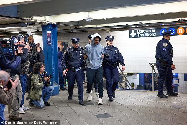 Kamel Hawkins, 23, (shown in gray) was charged with attempted murder and second-degree assault after allegedly pushing a person onto subway tracks Tuesday