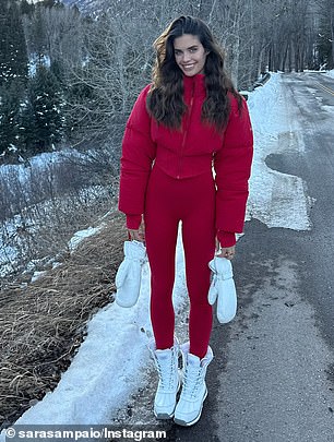 She turned the roadway into a runway and put on red leggings with a red puffy short jacket, which contrasted with snow-white boots and gloves