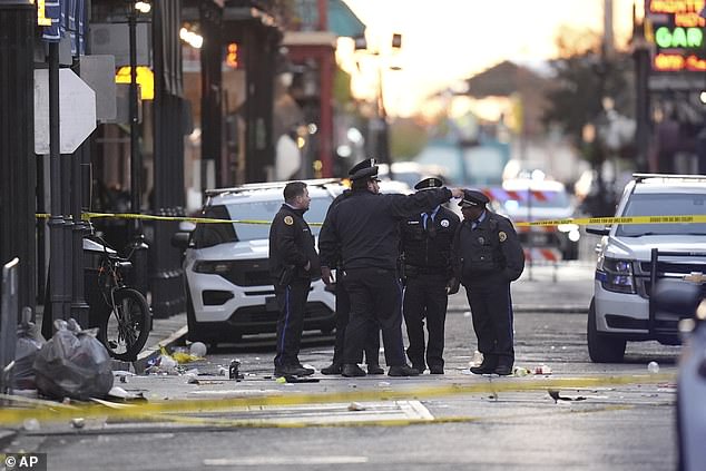 Law enforcement officers gather at the scene of the horrific attack on Bourbon Street