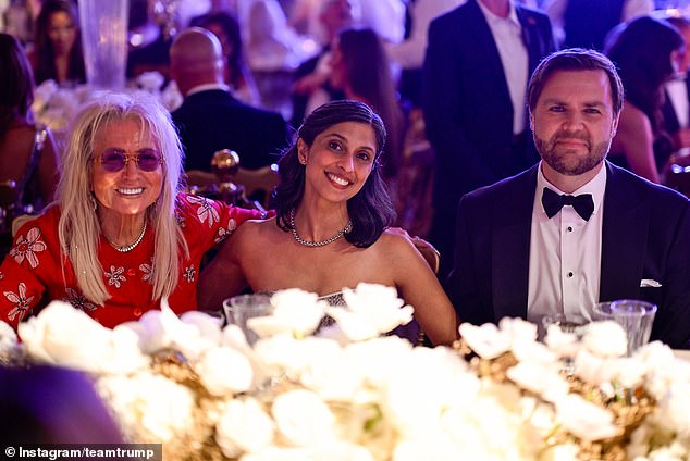 Vice President-elect JD Vance (right) and his wife Usha (center) pose for a photo with another Mar-a-Lago guest at Tuesday night's New Year's Eve party