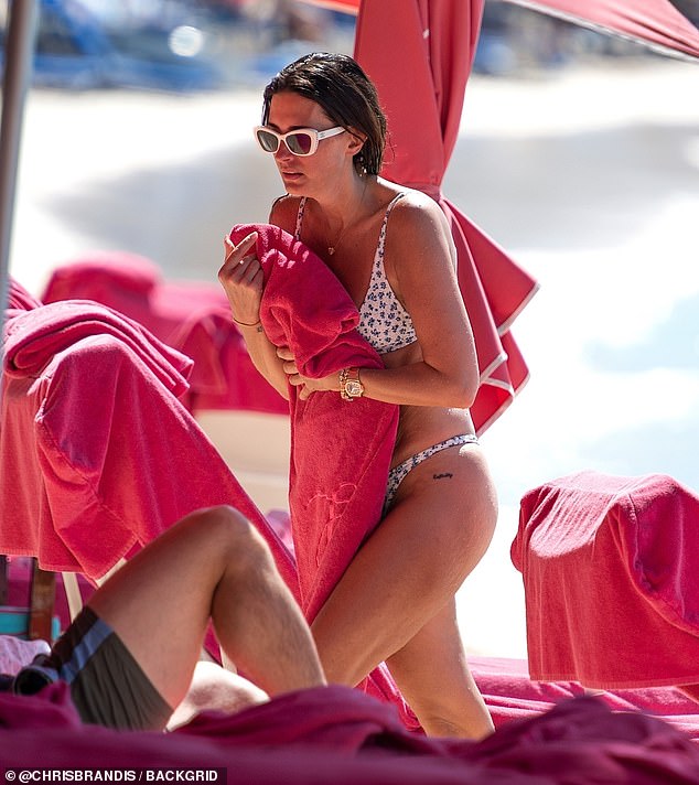 The inseparable Christian couple relaxed in the luxurious resort's shady lounger after swimming