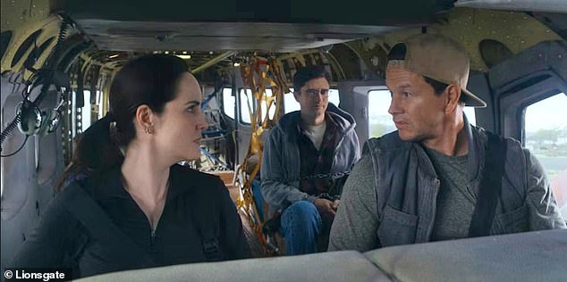 Wahlberg will next play pilot and assassin Daryl Booth in Mel Gibson's seventh directorial film Flight Risk, which hits UK/US theaters on January 24, alongside Michelle Dockery (L) and Topher Grace (M).