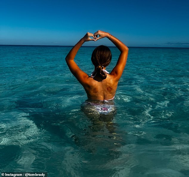 The photo collage also showed his daughter Vivian making a heart shape with her arms while standing in the water at a tropical destination