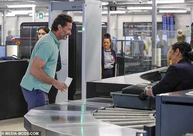 Hugh flashed his trademark smile at the security staff before boarding the plane