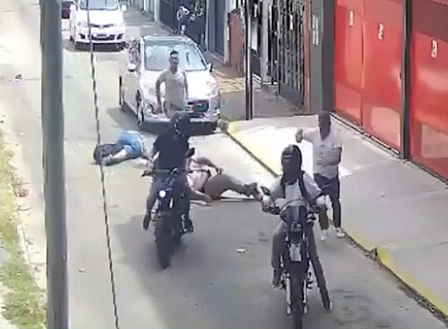 The robber ran towards one of his two accomplices (seen on the motorcycles) and fled