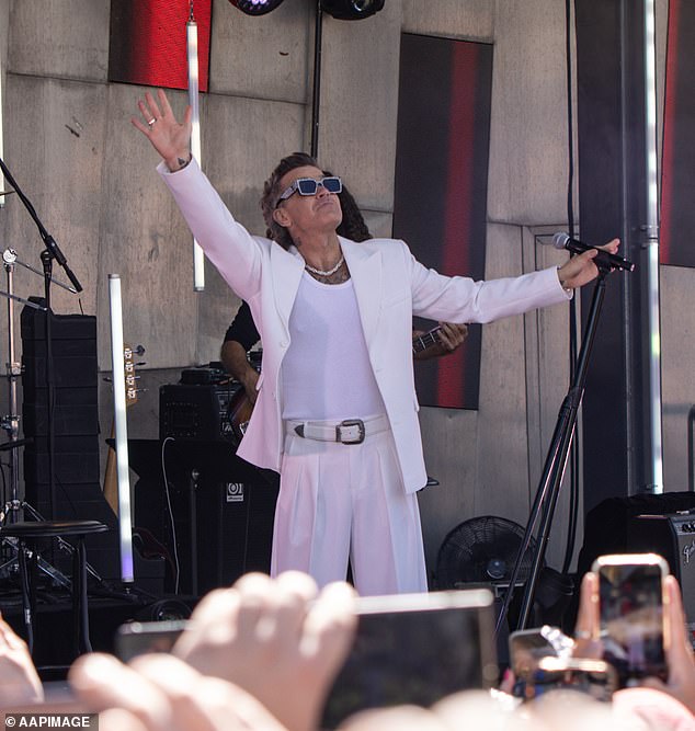 The award-winning hitmaker opened the show with his 1997 smash hit Let Me Entertain You, as he stepped out in a crisp white blazer and stunning sunglasses.